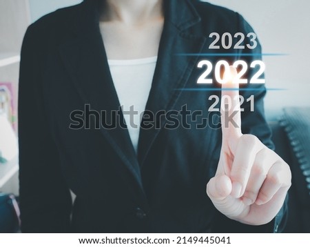 Business woman pointing at digital calendar 2022. New year start. New concept. Space for text.