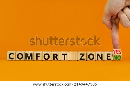 Yes or no comfort zone symbol. Businessman turns wooden cubes and changes words Comfort zone yes to Comfort zone no. Beautiful orange background, copy space. Business, psychology comfort concept. Royalty-Free Stock Photo #2149447385