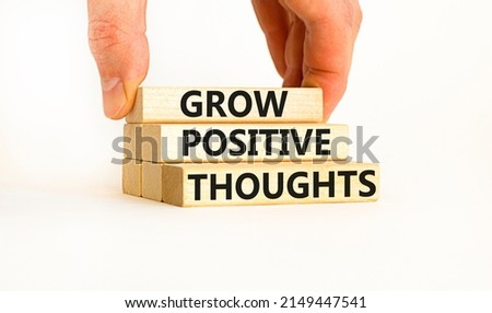 Grow positive thoughts symbol. Concept words Grow positive thoughts on blocks. Businessman hand. Beautiful white table white background. Business grow positive thoughts concept. Copy space.
