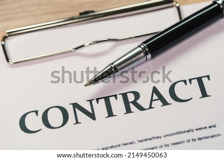 Pen and smartphone signature contract on paperwork background