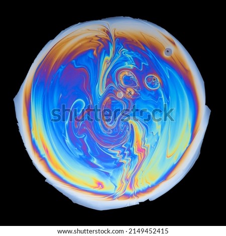 Interference colors from an oil film on water isolated on black background