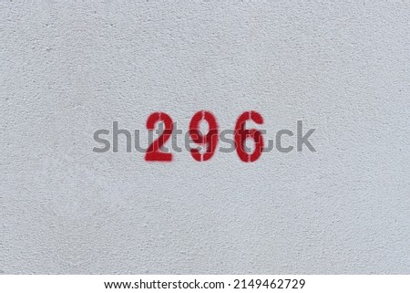 RED Number 296 on the white wall. Spray paint.two hundred ninety-sixtwo hundred ninety-six
