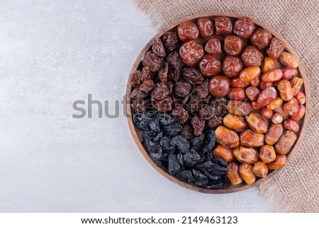 Dates or dattes palm fruit in wooden bowl is snack healthy, Set of various dates in bowl, Different kind of raw date fruit ready to eat, concrete background, Traditional, delicious and healthy ramadan Royalty-Free Stock Photo #2149463123