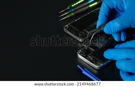 Technician repairing the Cell phone parts and tools for recovery repair phone smartphone and upgrade mobile technology,the concept of computer hardware inside. Royalty-Free Stock Photo #2149468677