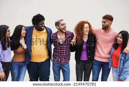 Group of happy multiracial people having fun together in the city - Concept of diversity - Focus on the african man