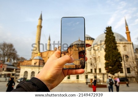 Using a mobile phone camera to take pictures of the Blue Mosque, Sultanahmet in Istanbul, Turkey