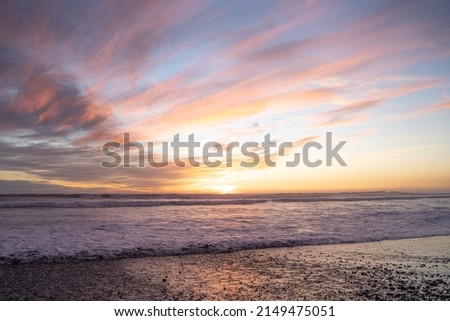 Colorful sunset over the waves at Concón beach, Chile