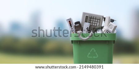 Waste bin full of electronics, e-waste and recycling concept Royalty-Free Stock Photo #2149480391