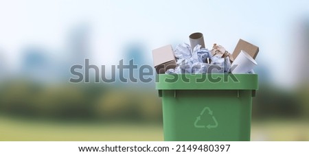 Garbage can full of paper waste, recycling and separate waste collection concept Royalty-Free Stock Photo #2149480397
