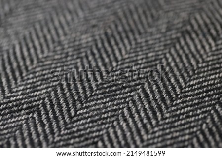 Closeup of black and white herringbone fabric. Texture fabric background concept