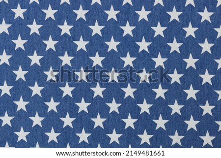 Blue fabric with white stars texture background. Stars seamless pattern concept