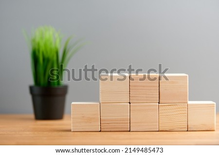 Ecology, business, seo, team, advertise concept, blank wooden block cubes on a gray background with plant for your text and advertisement. Free space for business concept template and banner..