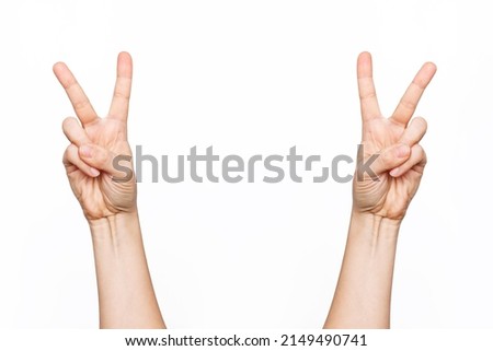 Two female hands showing a peace gesture isolated on a white background. Victory hand sign	
