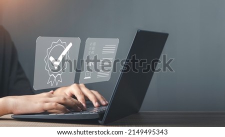 Businessman working on laptop with sign of Quality assurance, Guarantee, ISO certification and standardization. Compliance to regulations and standards, International information security standard.