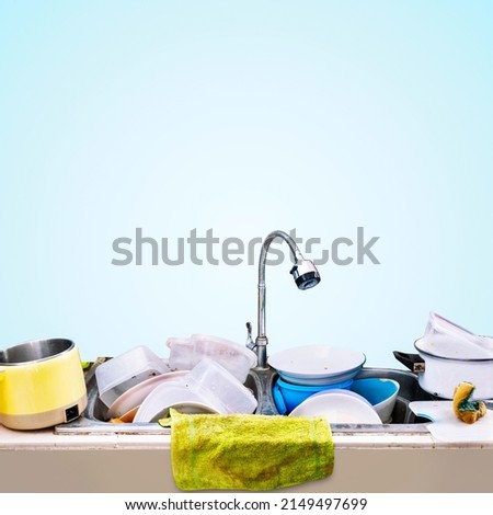 Dirty dishes piled up in the sink, Isolated on blue background. Royalty-Free Stock Photo #2149497699