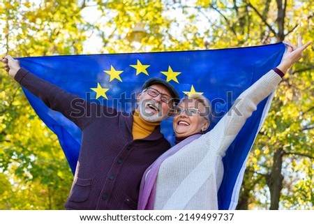 Senior couple holding european union flag outdoors Royalty-Free Stock Photo #2149499737
