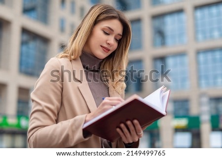 Young business woman taking a note