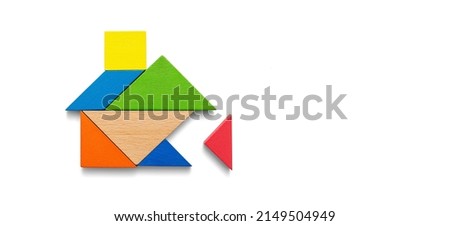 Wooden tangram puzzle wait to fulfill home shape for build dream home, happy life, house or mortgage investment concept