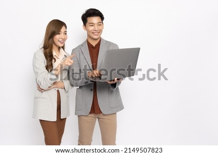 Asian businessman and businesswoman looking at laptop computer isolated on white background, Feeling happiness Royalty-Free Stock Photo #2149507823