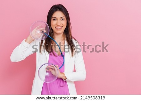 Professional beautician holding suction cups of pump up procedure, procedure for butt, beautiful ass. Royalty-Free Stock Photo #2149508319