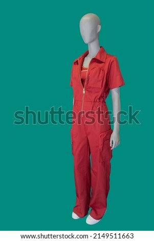 Full length image of a female display mannequin wearing fashionable red overalls isolated on a blue background Royalty-Free Stock Photo #2149511663