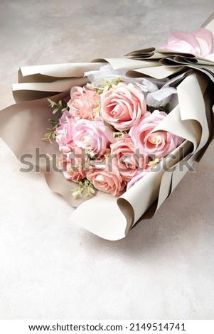 close up pink rose bucket an artificial flower look like real flowers. fake flower bouquet in
clean background 
