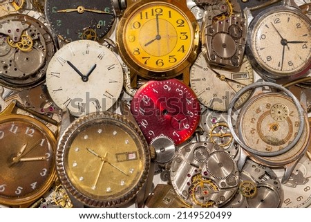 A lot of broken watches and their parts are scattered on the surface  Royalty-Free Stock Photo #2149520499