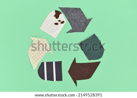 Recycling arrow symbol made from old textile pieces Royalty-Free Stock Photo #2149528391