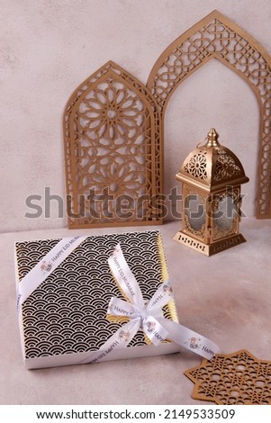 selective focus beautiful gift box for ramadan or eid mubarak or lebaran with golden lantern and mandala decoration
eye level, horizontal format and negative space