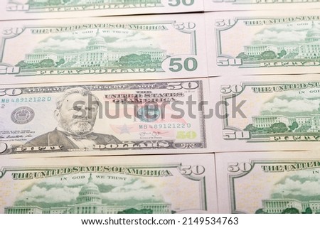 Close-up of fifty dollar bills spread out on the table. horizontal photo