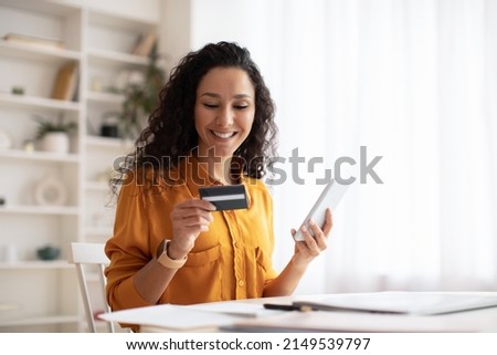 Happy Arabic Female Shopping Online Using Cellphone Making Payment Via Mobile Banking App Sitting At Desk In Office. Internet Commerce And Consumerism Concept