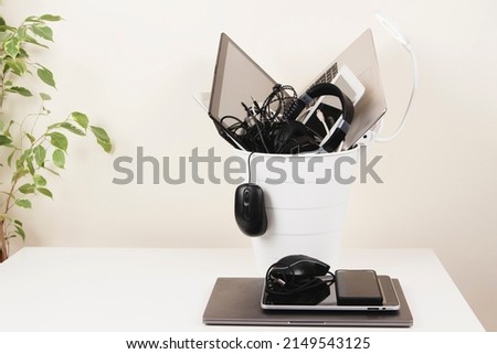 Planned obsolescence, e-waste, electronics waste for reuse and recycle concept. Recycling bin full of old electronic devices Royalty-Free Stock Photo #2149543125
