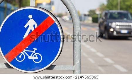 Cycle lane and pedestrian interrupted road signs