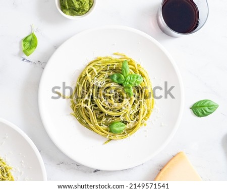 Pesto pasta with fresh basil garnishes and spooled on a fork Royalty-Free Stock Photo #2149571541