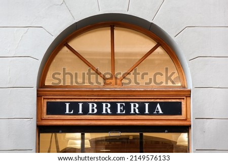 Elegant storefront sign of an Italian bookstore with cherry wood frames