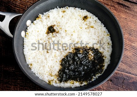 Sushi Rice that has Been Cooked with a Nori Sheet: Fresh sushi rice in a saucepan that has been cooked with a piece of seaweed