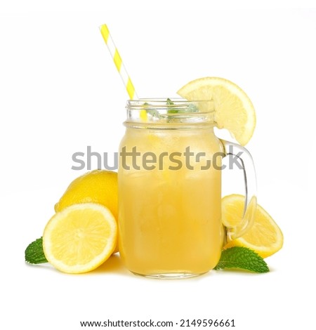 Summer iced green tea lemonade in a mason jar glass with paper straw, mint and lemons isolated on a white background