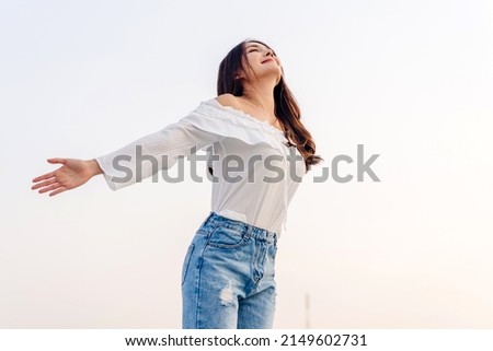 Smiling of cheerful beautiful pretty asian woman standing stretch her arms relax and enjoy with nature fresh air.asia beauty Royalty-Free Stock Photo #2149602731