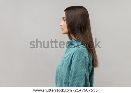 Side view of portrait of strict bossy woman looking ahead, feels confident focused self-assured, expressing seriousness, wearing casual style jacket. Indoor studio shot isolated on gray background. Royalty-Free Stock Photo #2149607535