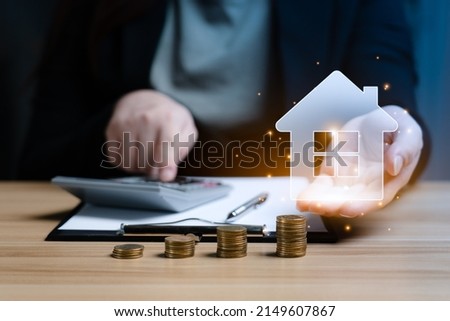 Real Estate Market Growth Concept.businesswoman or a home or real estate broker is calculating interest, taxes and profits on her desk.
