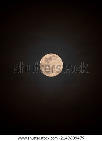 full moon illuminating clouds in the night