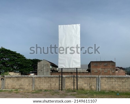 Blank white vertical advertising billboard on outdoor area