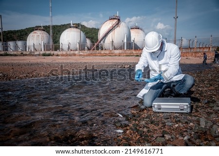 Scientist wearing safety uniform and glove under working water analysis and water quality by get fishes dead to check effected case in laboratory is environment pollution problem concept. Royalty-Free Stock Photo #2149616771