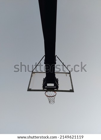 A low angle shot of a basketball board during dawn 