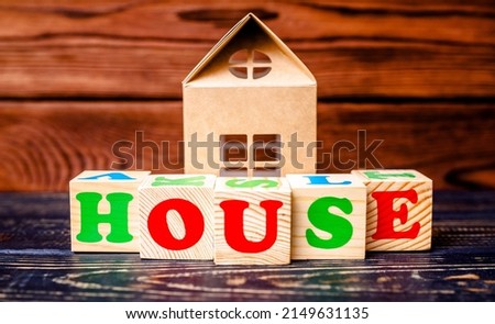 Wooden home and text on the cubes HOUSE 