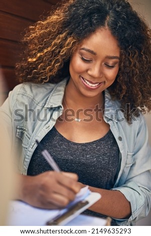 That was quick and convenient. Shot of a young woman signing for her delivery from the courier.