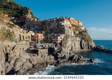 Beautiful view of rocky hills and colorful historic buildings of Manarola, tourist attraction and famous place in Liguria, Italy. 