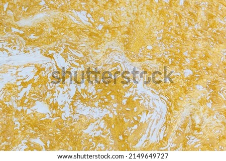 Gold liquid marble background. Used in design for skin tile ,wallpaper, interiors backdrop. Picture high resolution. Luxurious background