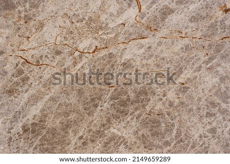 Brown marble texture with deep cracks. Horizontal photo.