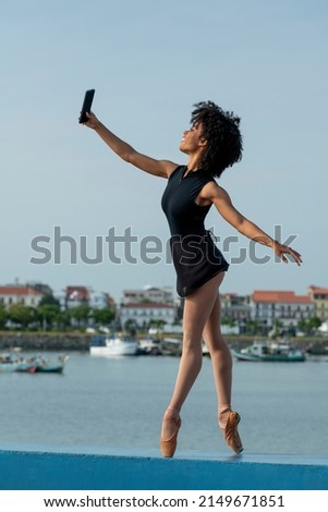 Woman in ballet dress with cell phone taking a selfie, Panama, Central America